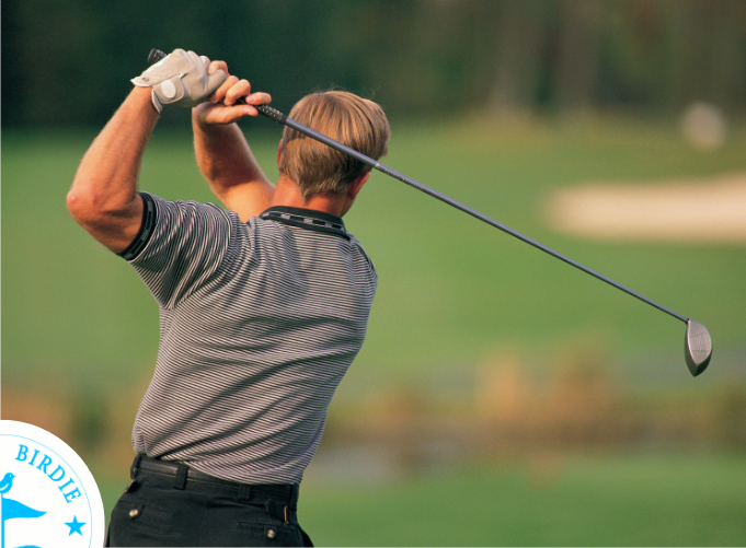 Golfer mid-swing in a Bunker Birdie simulator bay